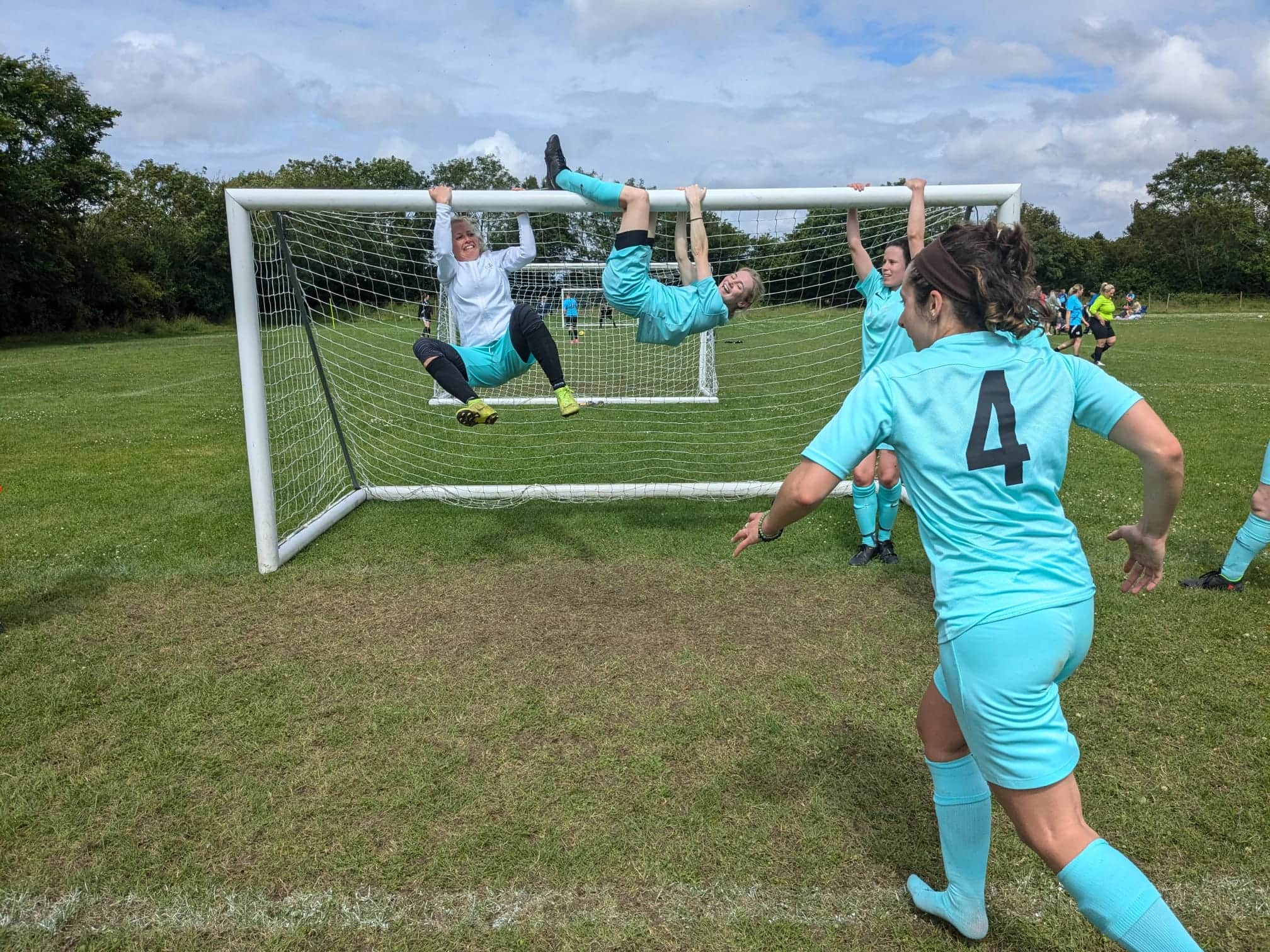 Left Field players hanging off the crossbar, celebrating